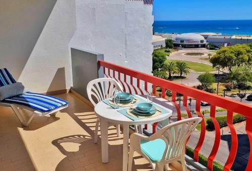 a balcony with a table and chairs and the ocean at Tivoli Apt8 with Pool&Garage in Vilamoura