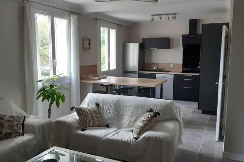 un salon avec un canapé et une cuisine dans l'établissement LA Maison D'AGEN, à Boé