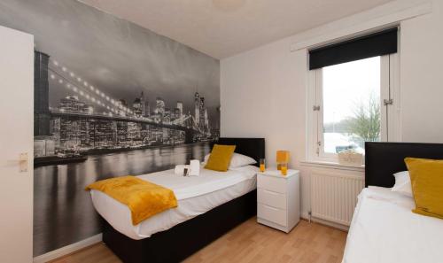 a bedroom with two beds and a wall mural at PREMIER - Chapel Street Apartment in Cleland