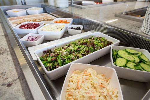 a buffet filled with different types of food in trays at Viking Hotel - Adults Only in Blackpool