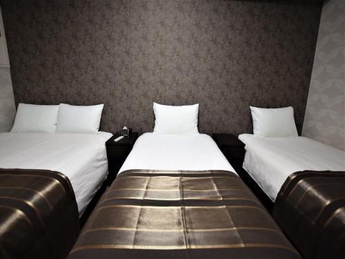 Ένα ή περισσότερα κρεβάτια σε δωμάτιο στο Land-Residential Hotel Fukuoka - Vacation STAY 81850v