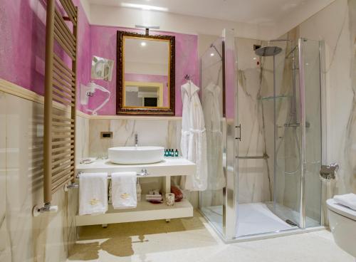 a bathroom with a sink and a shower at EGO' Boutique Hotel - The Silk Road in Venice