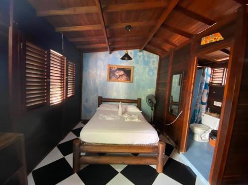 a small bedroom with a bed in a room at Dive and Green Capurgana in Capurganá