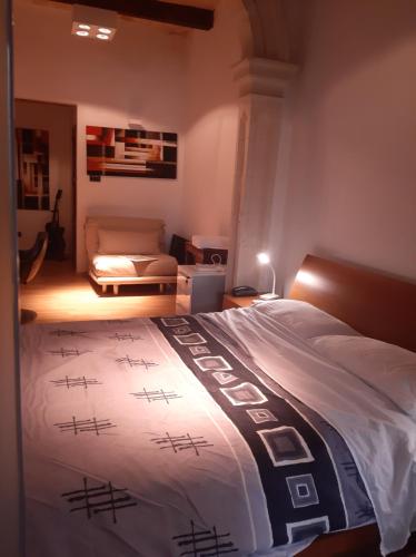 a bedroom with a bed and a living room at Nr65 Valletta Portview Apartment in Valletta
