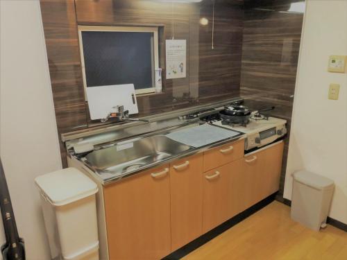 A kitchen or kitchenette at Maisonity Suizenji - Vacation STAY 10562v