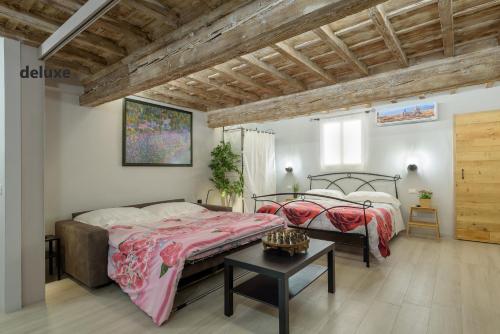 a bedroom with two beds and a table at Geppi's Apartments in Florence
