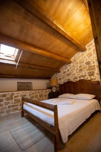 a bedroom with a bed in a stone building at SI-Moutique Le Case degli Avi barocche, con terrazza panoramica in Modica