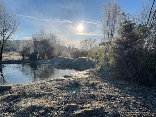 a body of water with the sun in the sky at PAGA Hotel in Aidenbach