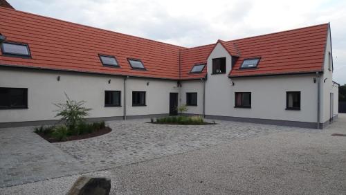 a large white building with a red roof at Côté Grange in Tournai