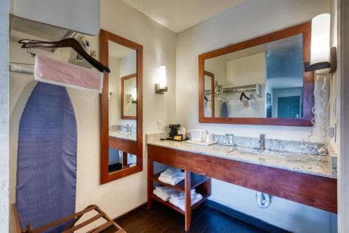 a bathroom with a sink and a mirror at Hotel Serene in Glendale