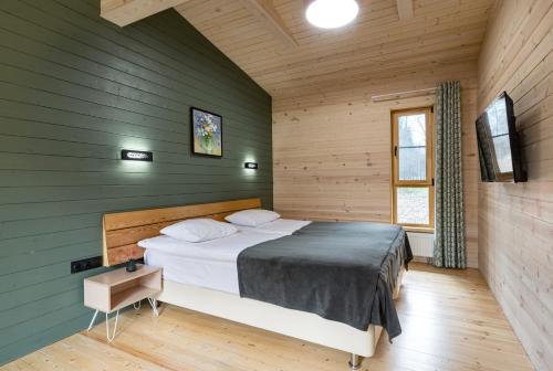 a bedroom with a bed in a room with green walls at Serebryaniy Vek in Tarusa
