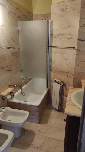 a bathroom with a tub and a toilet and a sink at Sea Breeze in Viareggio