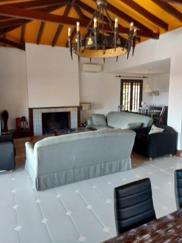 a living room with a couch and a fireplace at Villa con piscina privada in Torremolinos