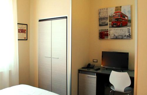 a bedroom with a closet and a desk with a computer at Aleksandr in Brindisi