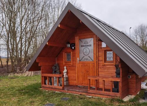 a large wooden cabin with a black roof at PAGA Hotel in Aidenbach