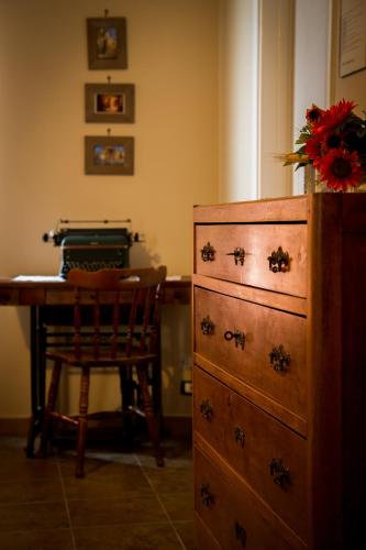 a bedroom with a dresser and a desk with a chair at B&B Kilometrozero in Supersano