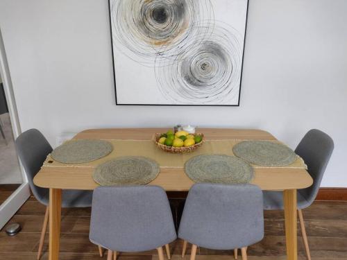 a wooden table with chairs and a bowl of fruit at White Birds Townhouse in Sligo Town Center in Sligo