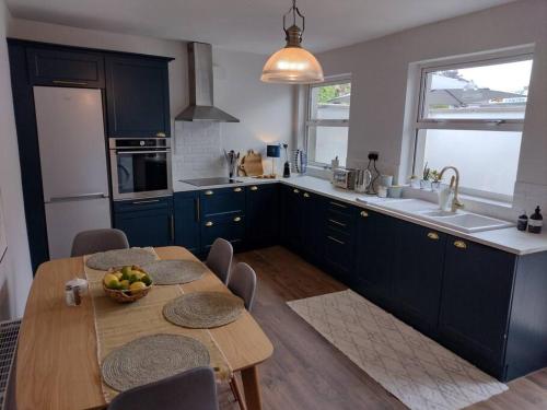 a kitchen with a table with a bowl of fruit on it at White Birds Townhouse in Sligo Town Center in Sligo
