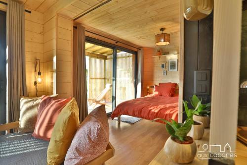 1 dormitorio con 1 cama y 1 sofá en una habitación en Aux Cabanes, en Grand-Laviers