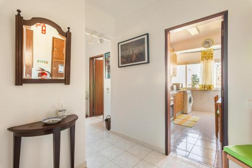 a living room with a table and a mirror at Isabel Dream III, 400m from the train in Rinchoa