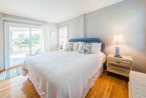 a bedroom with a large bed and a window at A Summer Place in Duck