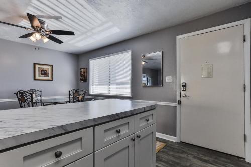 a kitchen with a ceiling fan and a table at Coastal Waters in New Smyrna Beach