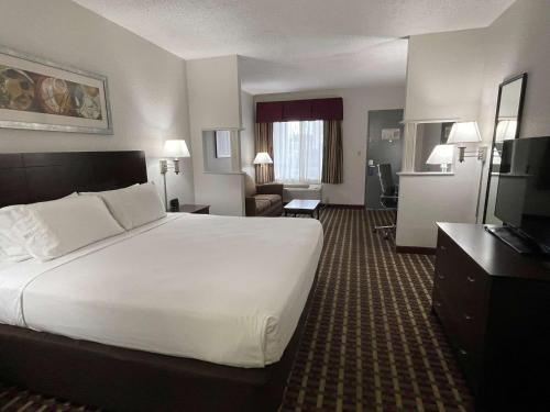 a hotel room with a large bed and a couch at Best Western of Clewiston in Clewiston