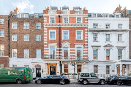 a group of cars parked in front of buildings at 20 Hertford Street - Mayfair Apartments in London