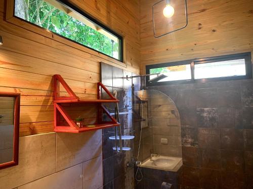 a bathroom with a shower and a toilet and a sink at Ocean Melody 3 in Uvita