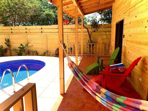 a hammock on a patio next to a pool at Ocean Melody 3 in Uvita