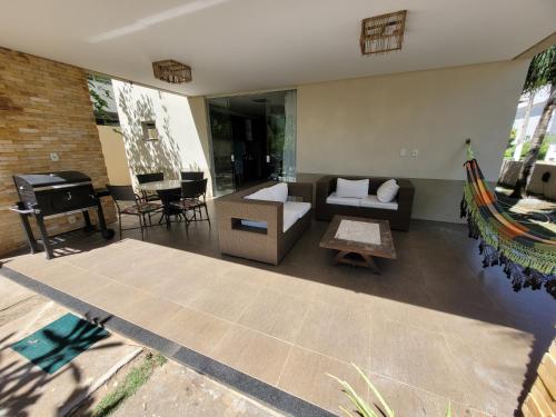 a living room with a couch and a piano at Fantástica casa 4 quartos próxima a praia em condomínio fechado ! in Aracaju