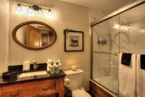 y baño con ducha, aseo y lavamanos. en Les Manoirs Wpool & Hot Tub Near Village 110-7, en Mont-Tremblant