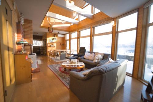 a living room with couches and a table at The lakeview toya Shirokumanoyado in Lake Toya