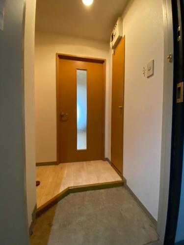 an empty hallway with a door and a floor at Near Nakajima park Close to Susukino Anbiennte 101 in Sapporo