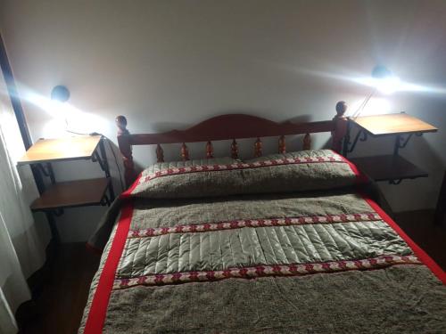a bedroom with a bed with two end tables at LOS LILOS - Otros Aires in Tilcara