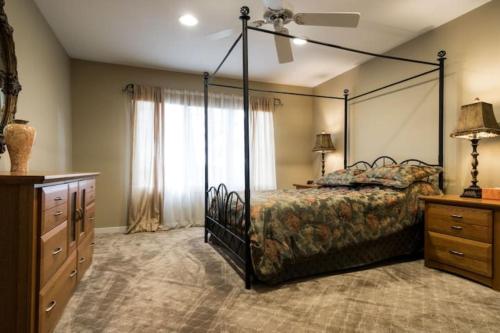 a bedroom with a canopy bed and a dresser at Nature living Luxury private Home pristine lake in Wolverine Lake