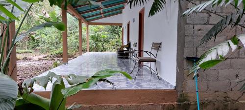 a porch of a house with a bench on it at Cabaña Sak Ja Selva Lacandona in Nuevo Progreso