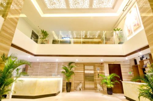 a lobby with potted plants in a building at Commander Suites de Boracay in Boracay