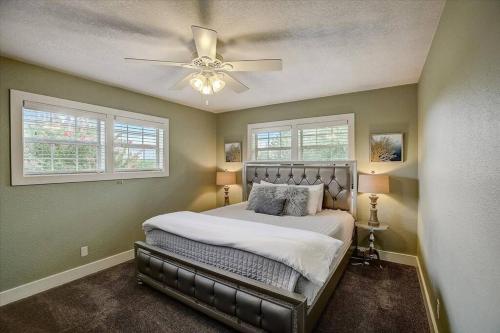 a bedroom with a bed with a ceiling fan at Sandy Feet Retreat on LBJ - Pool, Hot Tub, Kayaks in Kingsland