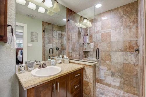 a bathroom with a sink and a shower at Sandy Feet Retreat on LBJ - Pool, Hot Tub, Kayaks in Kingsland