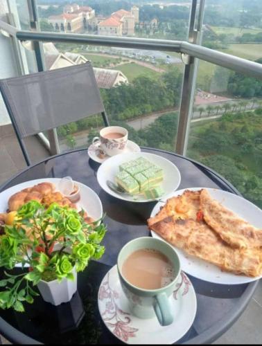 a table with plates of food and a cup of coffee at ALMAS PUTERI HARBOUR in Nusajaya