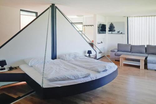 a swing bed in a living room with a couch at 4 star holiday home in Gaal im Murtal in Pirkach