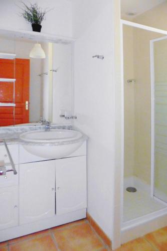 une salle de bain blanche avec un lavabo et une douche dans l'établissement Cottage in Brittany with Stunning Sea Views, à Telgruc-sur-Mer