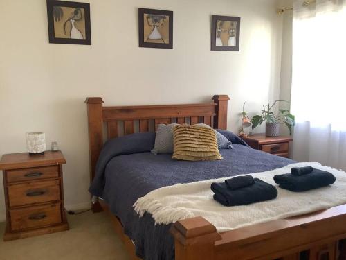 a bedroom with a bed with two towels on it at Maggie's Nest-Come & Rest in Killarney Vale