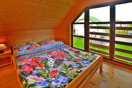 a bed in a room with a window at Holiday resort, Grzybowo in Grzybowo