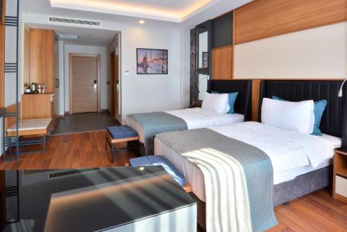 Postel nebo postele na pokoji v ubytování Expoist Hotel