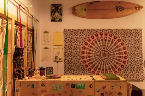 a room with a surfboard hanging on the wall at Hope Hostels, Varkala - Helipad in Varkala