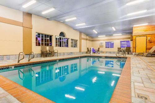 a large swimming pool in a hotel room at AmericInn by Wyndham Des Moines Airport in Des Moines