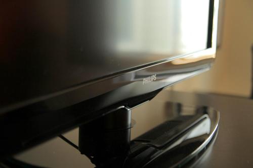a black computer monitor sitting on top of a table at AmericInn by Wyndham Des Moines Airport in Des Moines
