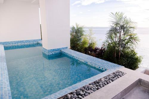 a swimming pool with a view of the ocean at Lime Resort Manila in Manila